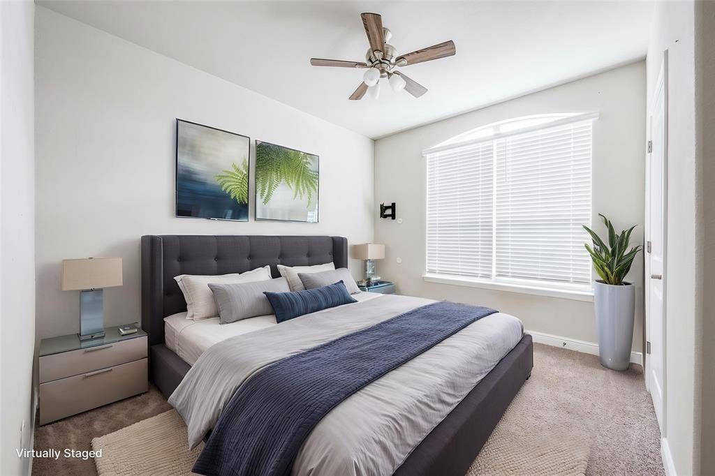 1548 Seabiscuit Drive, Granbury, TX 76049 Arched window with blinds, ceiling fan, and carpeted flooring
