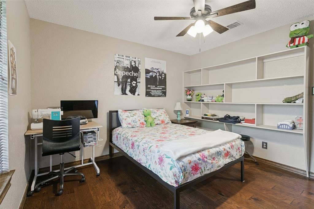 6801 Bellaire Court S, Benbrook, TX 76132 Built-in shelving, wood-finish flooring, ceiling fan, neutral wall paint, and window with blinds