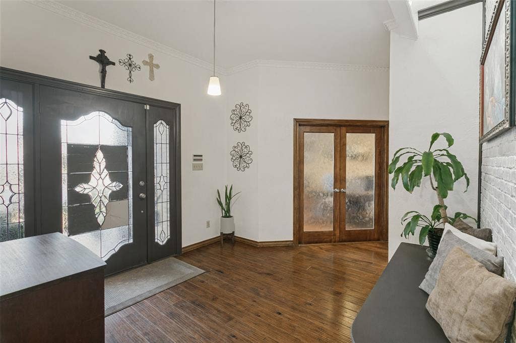 6801 Bellaire Court S, Benbrook, TX 76132 Entryway featuring wood-finish flooring, a double entry door with decorative glass, and a pendant light fixture