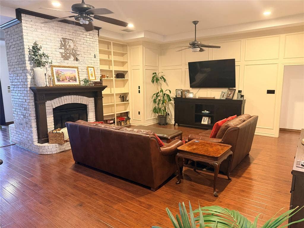 6801 Bellaire Court S, Benbrook, TX 76132 Warm living room with book shelves and fireplace