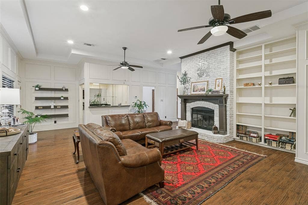 6801 Bellaire Court S, Benbrook, TX 76132 Dual Ceiling fans, floating shelves and a wet bar enhance the living rea
