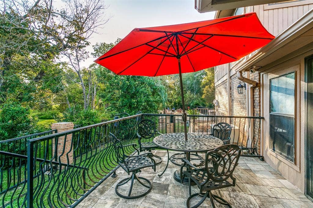6801 Bellaire Court S, Benbrook, TX 76132 Exterior balcony featuring a tiled surface, black wrought iron railing, and a window with trim