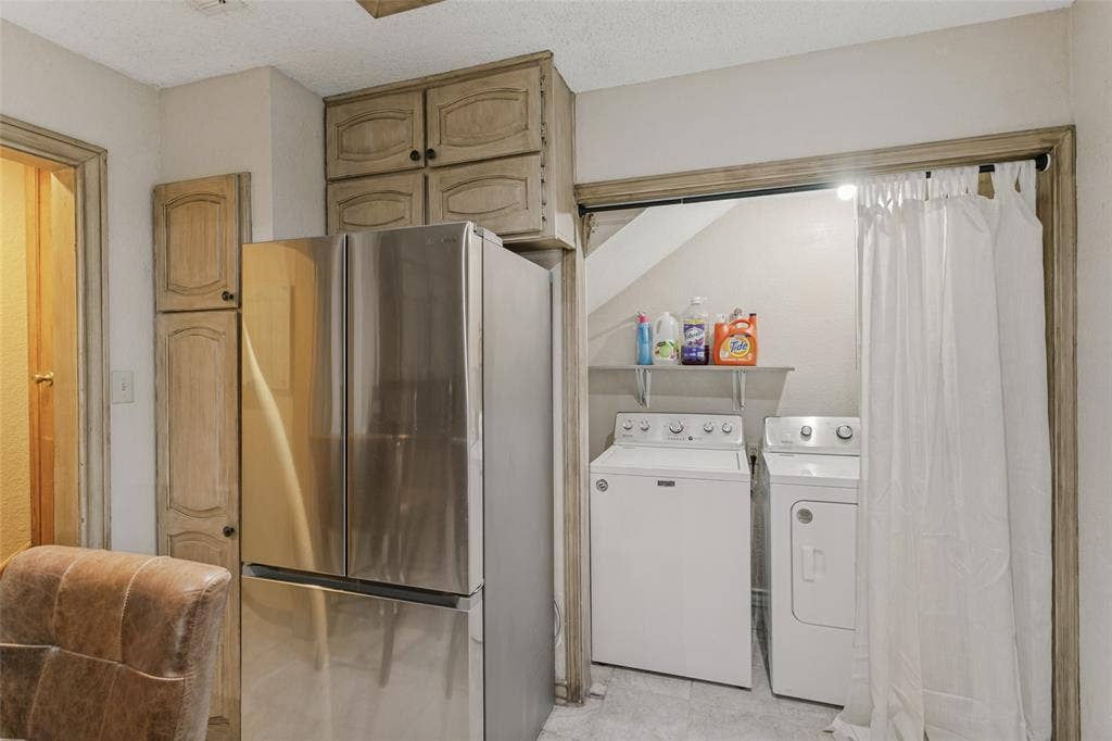 6801 Bellaire Court S, Benbrook, TX 76132 Integrated laundry area with shelving and a full-size washer and dryer