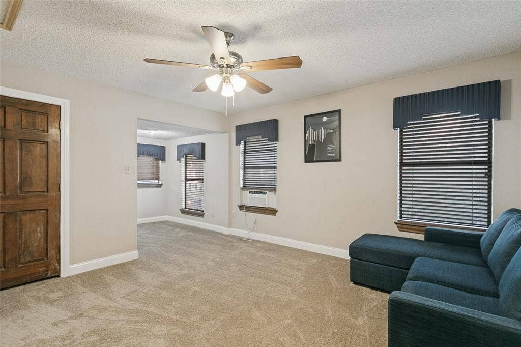 6801 Bellaire Court S, Benbrook, TX 76132 Upstairs bedroom features Wall-to-wall carpeting with light-toned walls, a decorative ceiling fan, and paneled wood doors