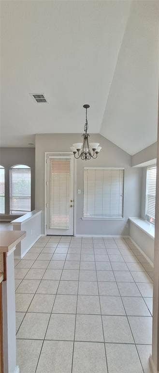 7403 Stone Hearth Drive, Frisco, TX 75035 Vaulted ceiling, decorative chandelier, tiled flooring, built-in window seating, and a glass-paneled door