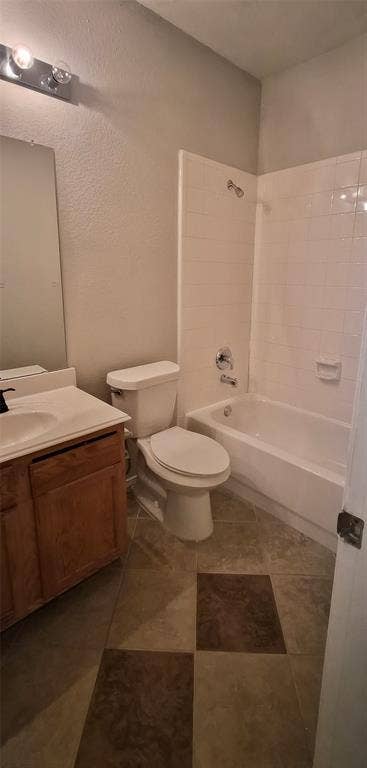 7403 Stone Hearth Drive, Frisco, TX 75035 Bathroom featuring a vanity with an integrated sink, a toilet, and a bathtub with a shower