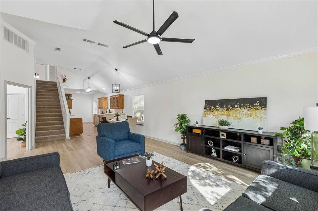 1503 Milla Court, Euless, TX 76039 Vaulted ceiling with a ceiling fan, wood-finish flooring, and a carpeted staircase
