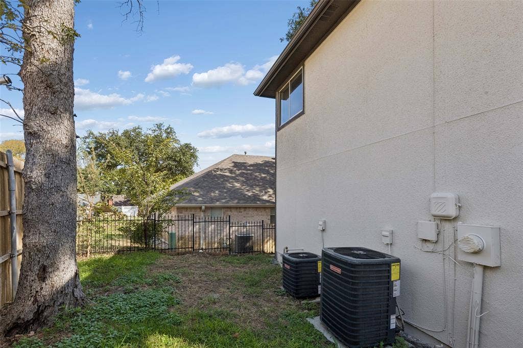 1503 Milla Court, Euless, TX 76039 Stucco exterior featuring dual HVAC units and a rear window