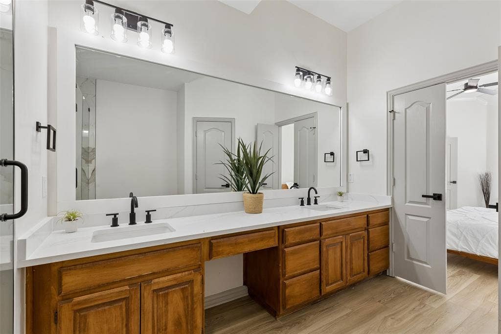 1503 Milla Court, Euless, TX 76039 Dual vanity with white countertops, undermount sinks, and matte black fixtures