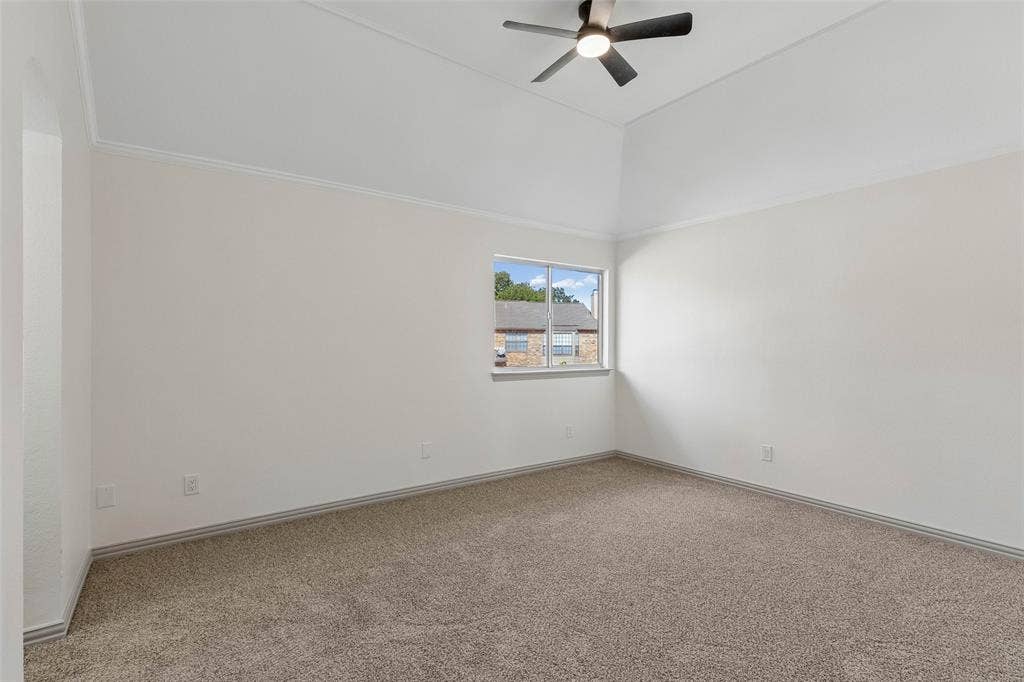 1503 Milla Court, Euless, TX 76039 Vaulted ceiling with crown molding, ceiling fan with integrated lighting, carpeted flooring, and a single window