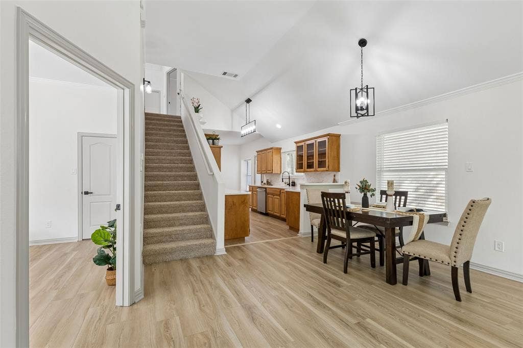 1503 Milla Court, Euless, TX 76039 Vaulted ceilings, wood-finish flooring, carpeted staircase, recessed lighting, and kitchen with wood cabinetry