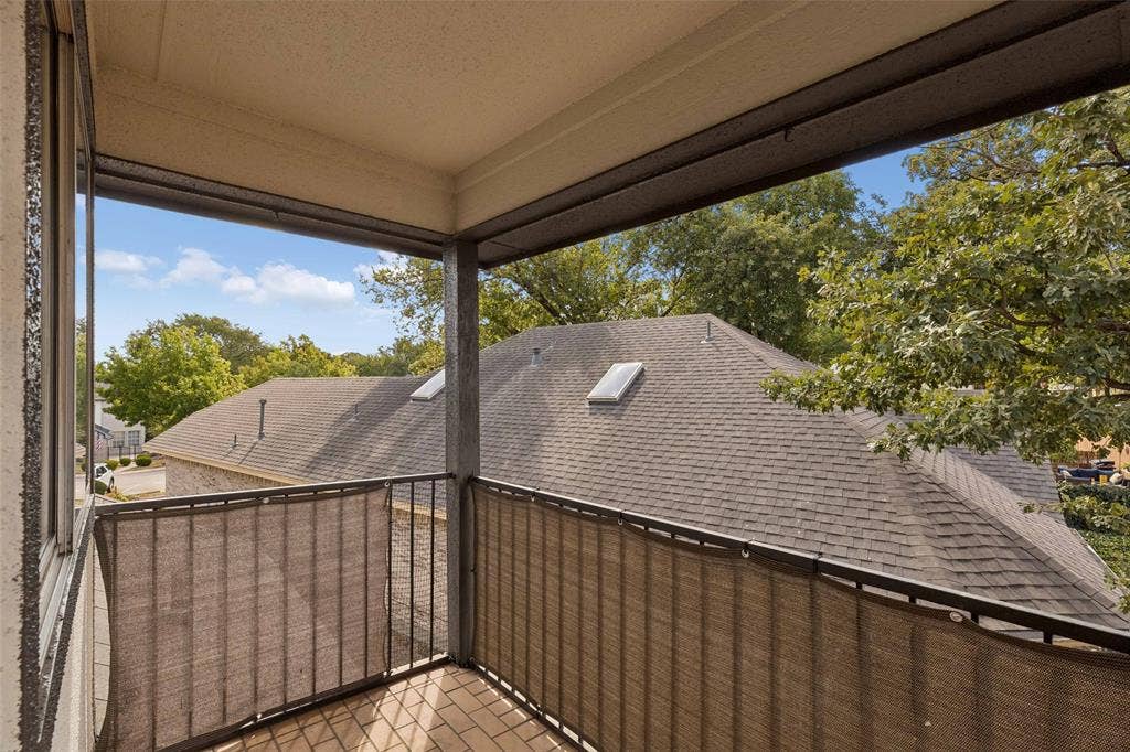1503 Milla Court, Euless, TX 76039 Balcony with brick paver flooring, metal railing, and privacy screening