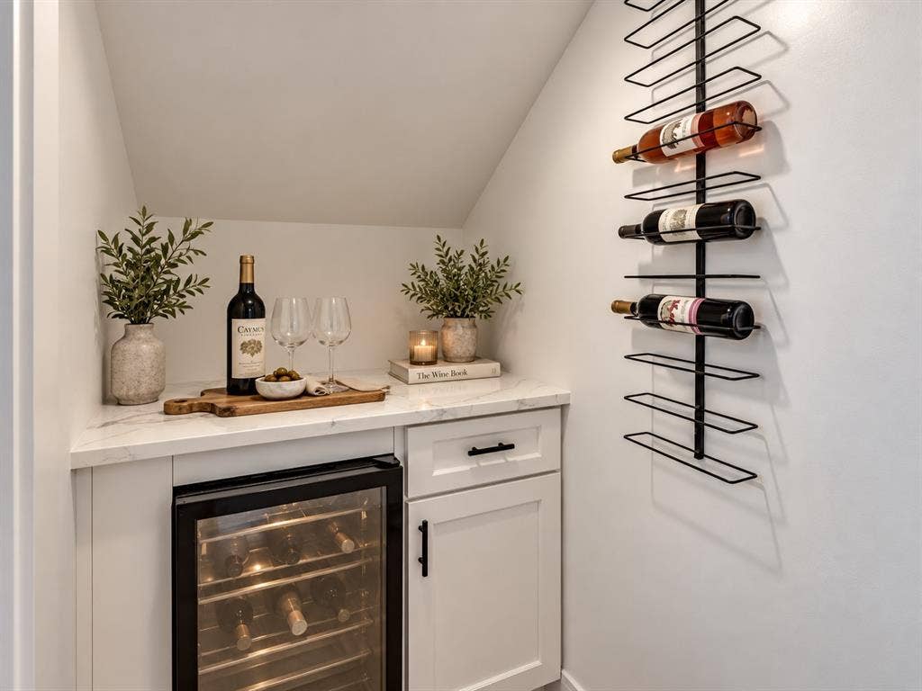 2806 Guymon Street, Dallas, TX 75212 Built-in beverage cooler beneath a light-colored countertop, complemented by white cabinetry and a wall-mounted wine rack
