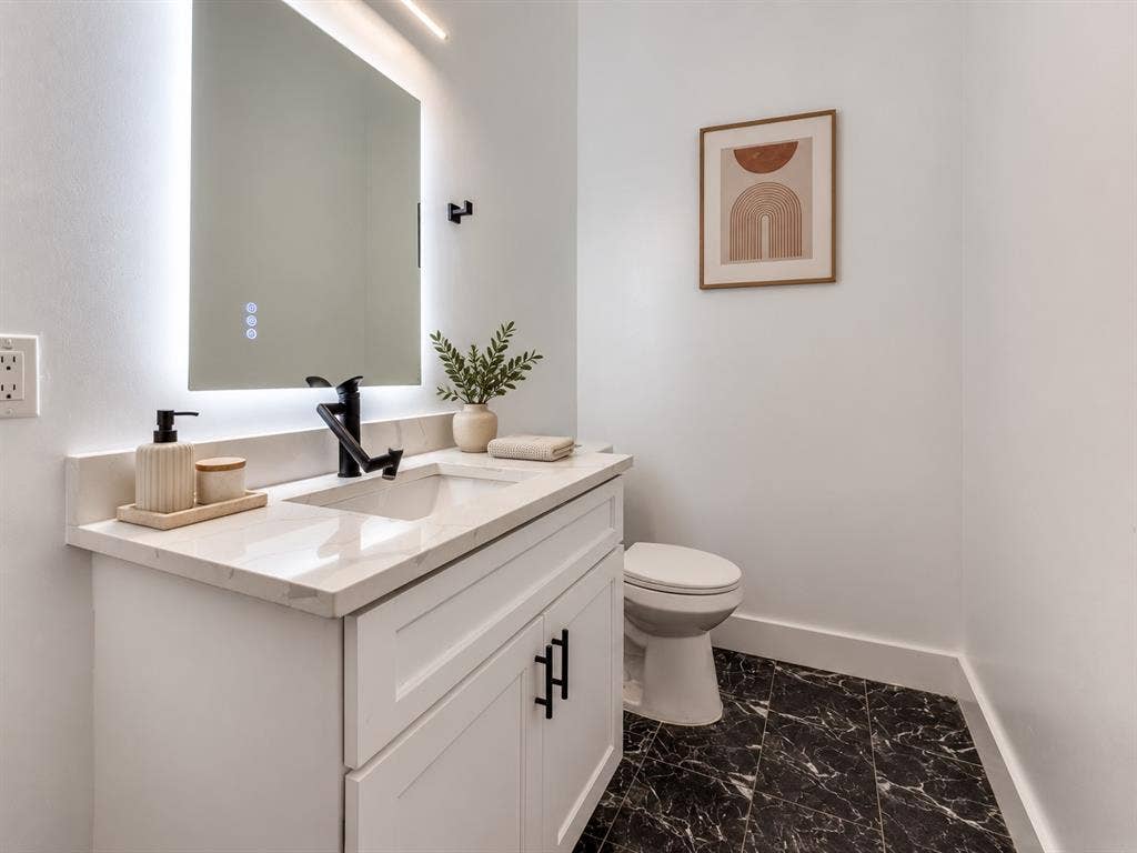 2806 Guymon Street, Dallas, TX 75212 White vanity with shaker-style doors, matte black hardware, and a light-toned countertop