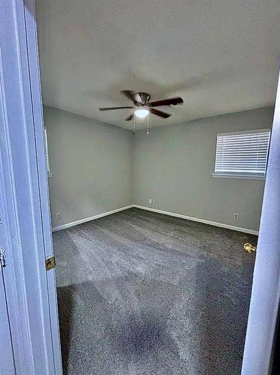 2115 N 9th Street, Temple, TX 76501 Gray carpeted flooring, light gray wall paint, and a ceiling fan with integrated lighting