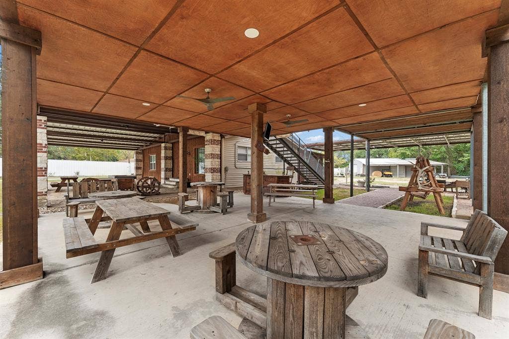 5989 State Highway 31 E, Murchison, TX 75778 Covered patio with exposed wood-finish ceiling, recessed lighting, ceiling fans, and concrete flooring