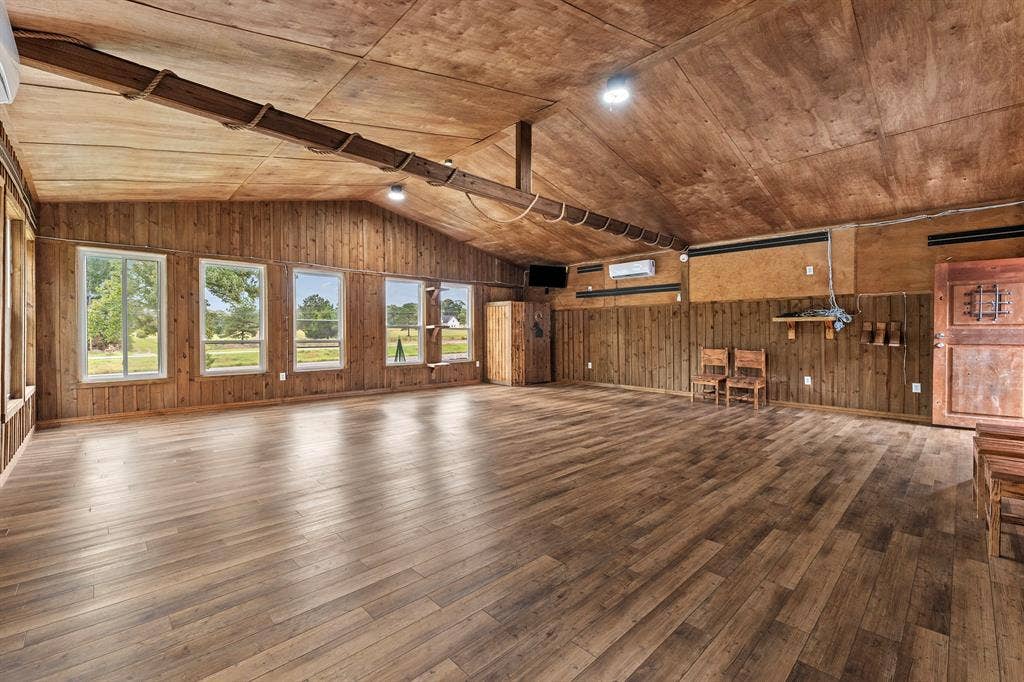 5989 State Highway 31 E, Murchison, TX 75778 Vaulted wood-finish ceilings, wood-finish flooring, wood paneling, and multiple windows