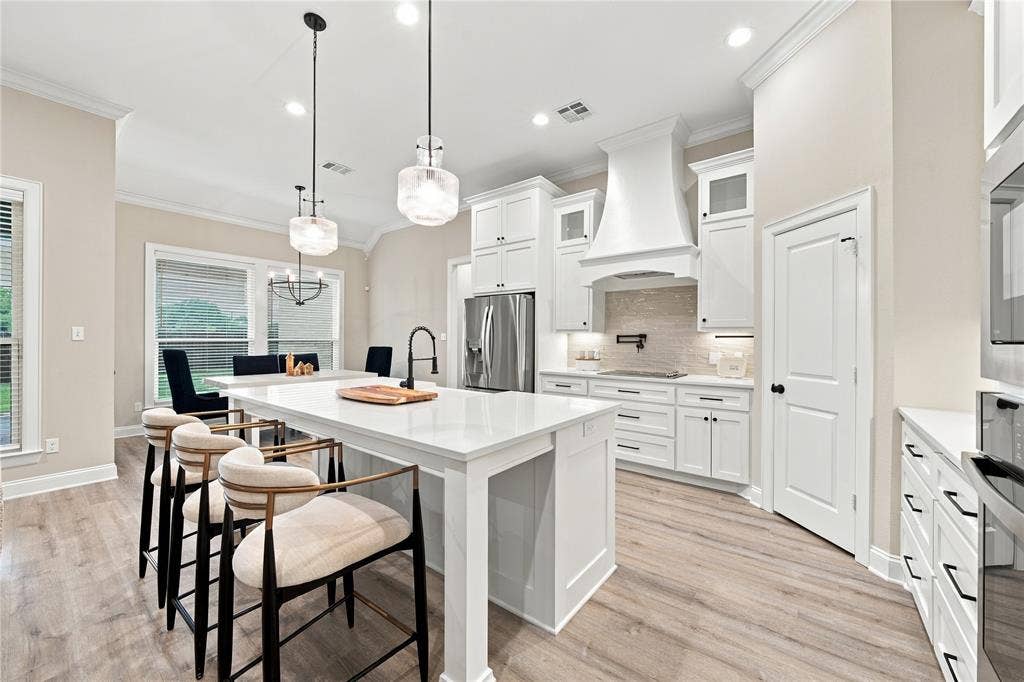 10201 Castleberry Lane, Waco, TX 76712 Kitchen featuring white cabinetry, wood-finish flooring, a central island with a sink, stainless steel appliances, and recessed lighting