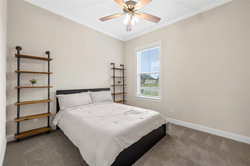 10201 Castleberry Lane, Waco, TX 76712 Recessed lighting, wood-finish ceiling fan with integrated lighting, window with blinds, carpeted flooring, and crown molding