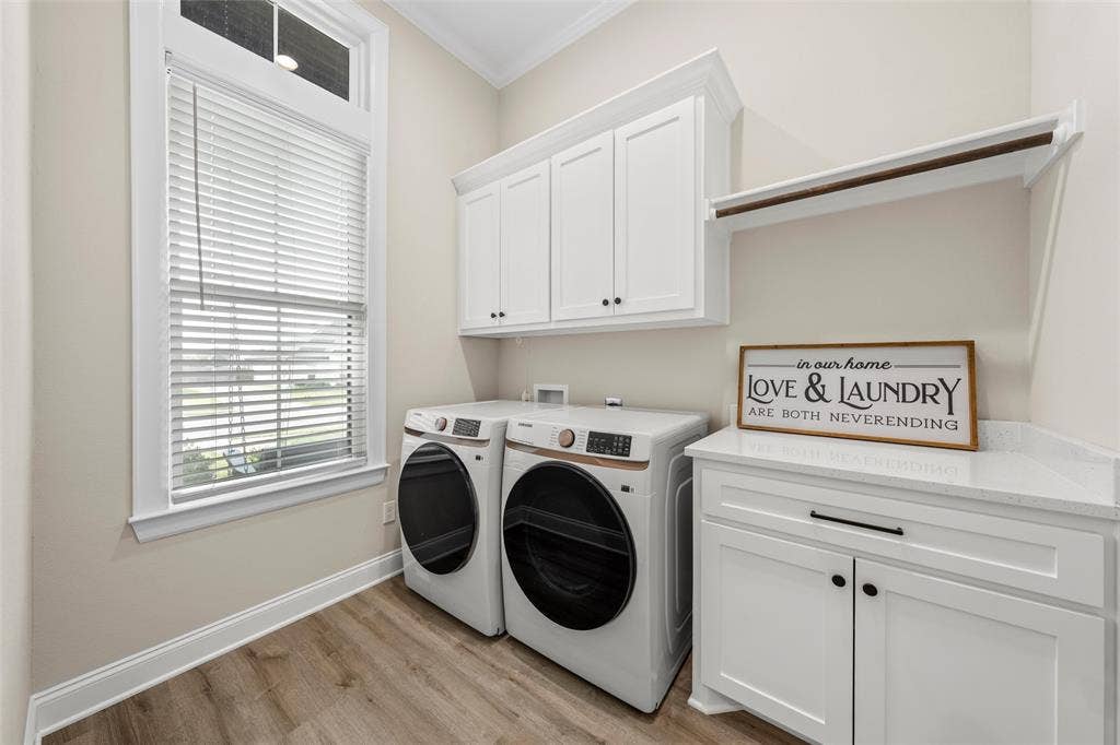 10201 Castleberry Lane, Waco, TX 76712 Built-in white cabinetry, wood-finish flooring, white window trim, and a white countertop