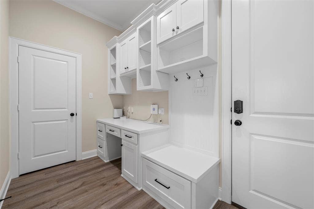 10201 Castleberry Lane, Waco, TX 76712 Built-in white cabinetry with open shelving, integrated desk, and storage bench