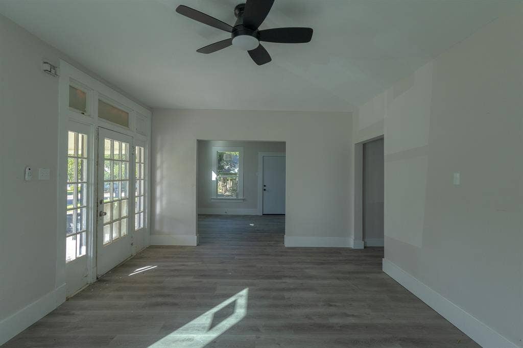 1702 Ethel Avenue, Waco, TX 76707 Wood-finish flooring throughout, ceiling fan, white trim, and a glass-paneled double door with transom window