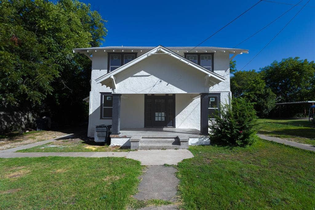 1702 Ethel Avenue, Waco, TX 76707 Two-story residence with white stucco exterior, prominent front porch, and dark trim details