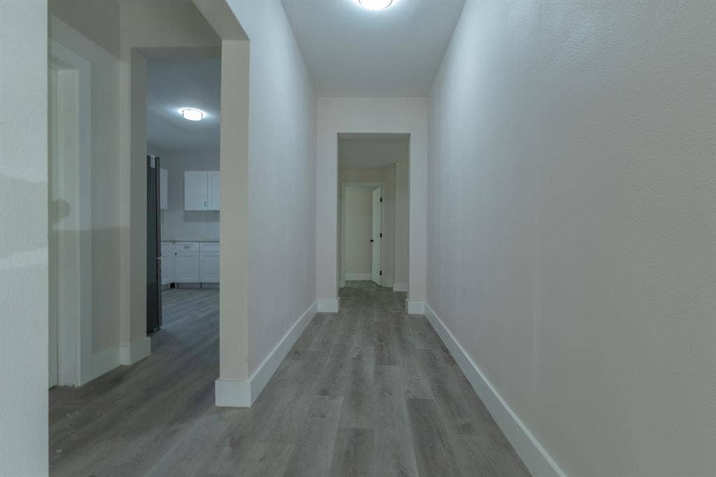 1702 Ethel Avenue, Waco, TX 76707 Hallway with light wood-finish flooring, white trim, and recessed lighting