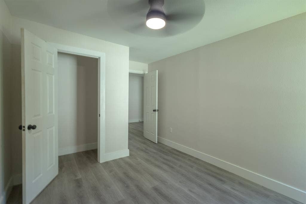 1702 Ethel Avenue, Waco, TX 76707 Room featuring wood-finish flooring, light-toned walls, a ceiling fan with integrated lighting, and a closet with a white paneled door