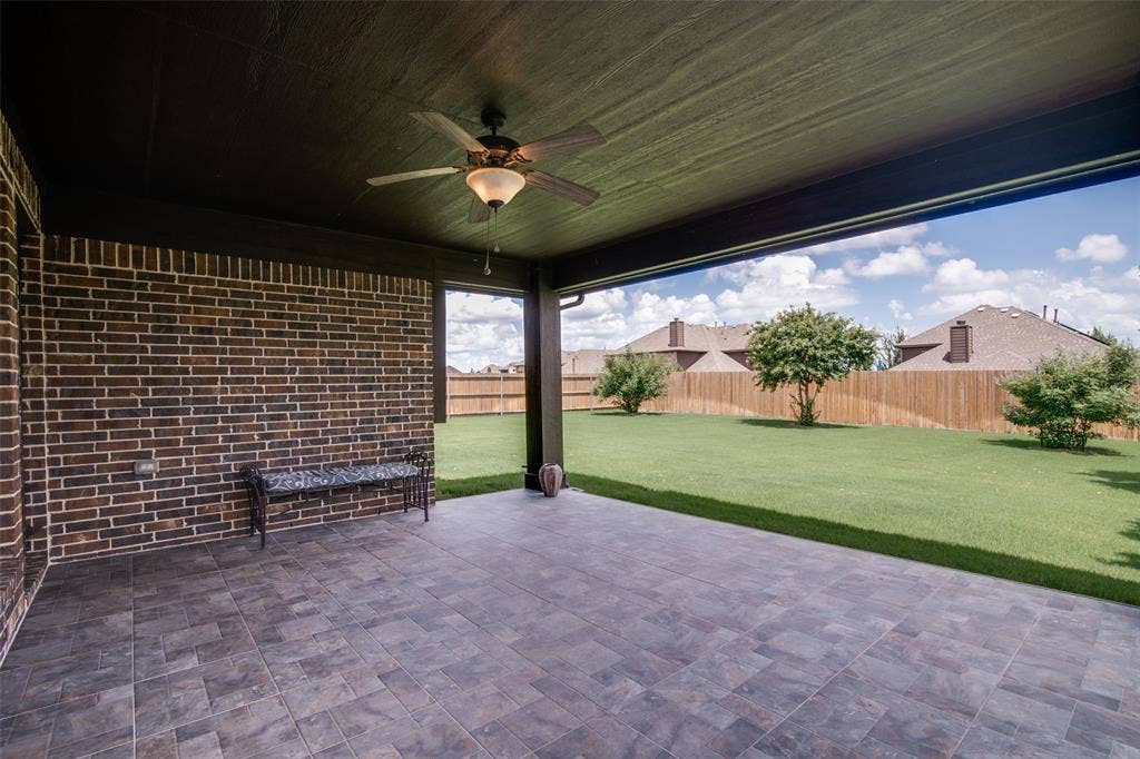1813 Chadwick Lane, Forney, TX 75126 Covered patio featuring a ceiling fan, brick accent wall, and tile flooring