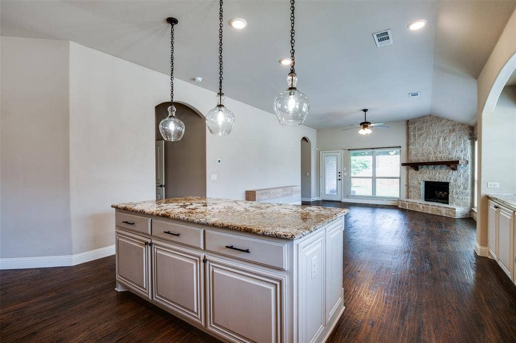 1813 Chadwick Lane, Forney, TX 75126 Kitchen island with granite countertop and pendant lighting