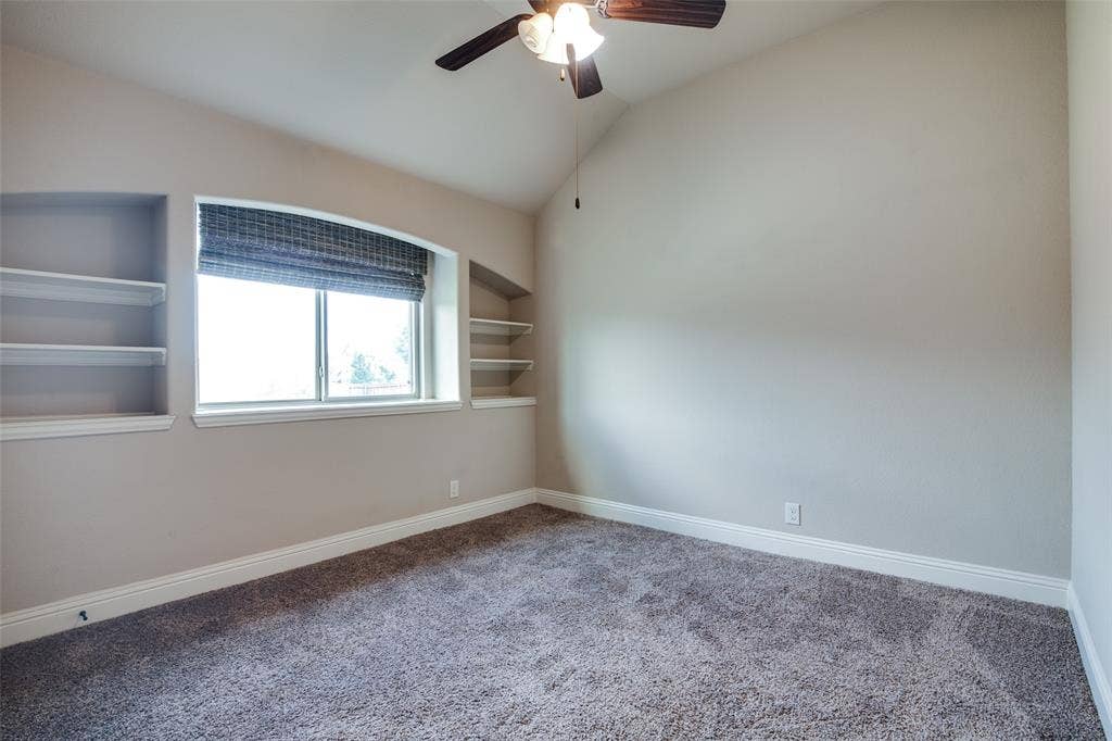 1813 Chadwick Lane, Forney, TX 75126 Vaulted ceiling, built-in shelving, window with blind, ceiling fan with light, and carpeted flooring