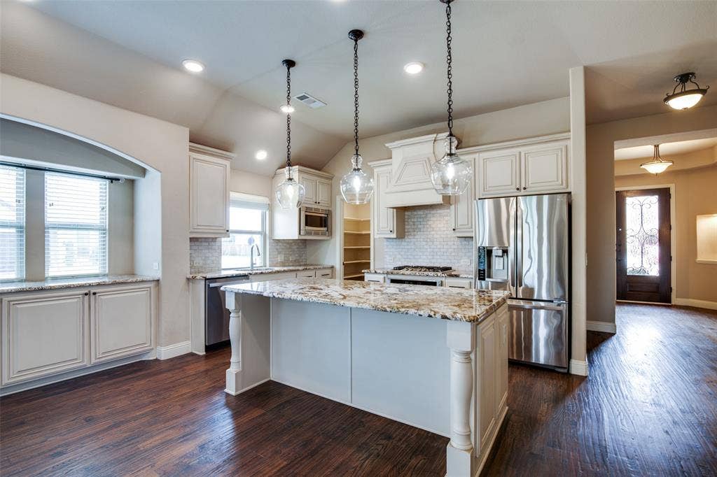 1813 Chadwick Lane, Forney, TX 75126 Wood-finish flooring, recessed lighting, white cabinetry, granite countertops, and stainless steel appliances