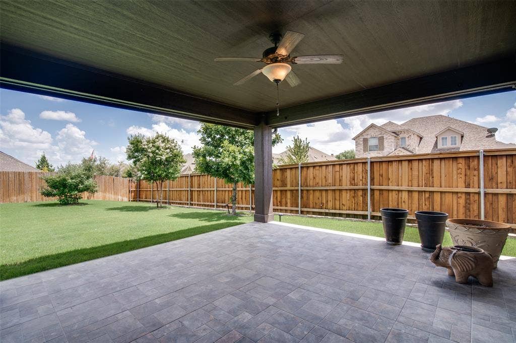 1813 Chadwick Lane, Forney, TX 75126 Covered patio featuring a ceiling fan with integrated lighting, paver flooring, and a manicured lawn