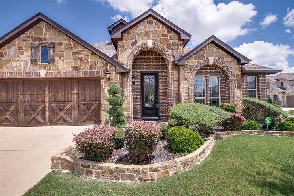 1813 Chadwick Lane, Forney, TX 75126 Stone and brick exterior with arched windows and entry