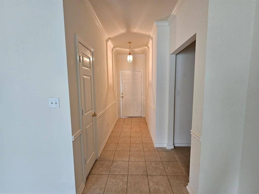 1521 Rice Road, #Z-101, Tyler, TX 75703 Carpeted living area featuring a fireplace with a mantel, a ceiling fan, a window with blinds, and a white door with a window