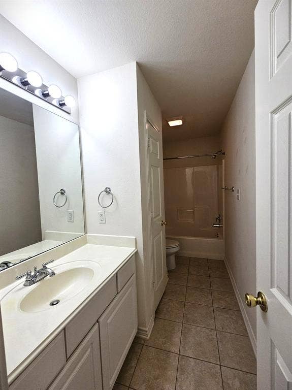 1521 Rice Road, #Z-101, Tyler, TX 75703 Vanity with an integrated sink, polished chrome faucet, and storage cabinetry