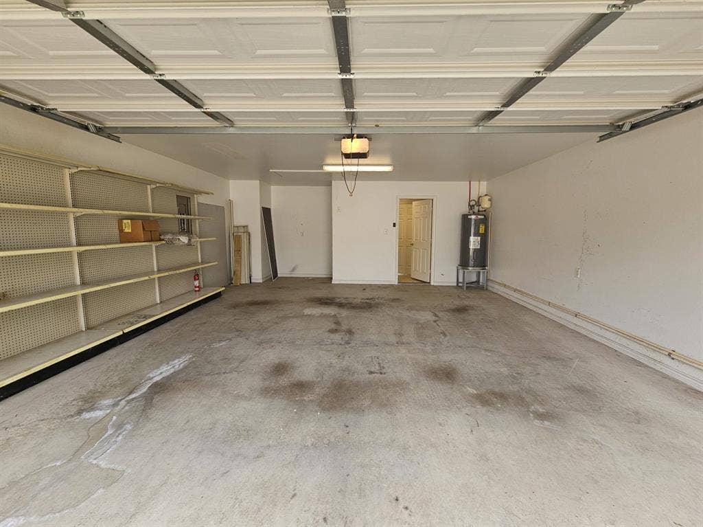 1521 Rice Road, #Z-101, Tyler, TX 75703 Tile flooring, single vanity with integrated sink, built-in shower, window with blinds, and wall-mounted cabinetry