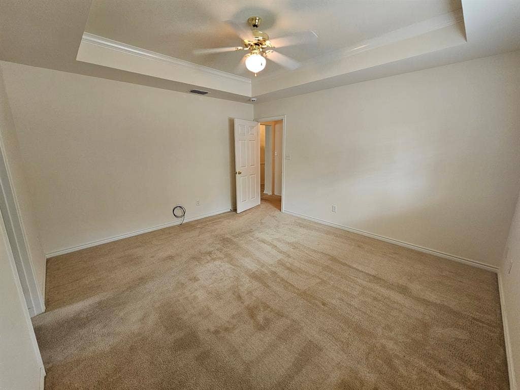 1521 Rice Road, #Z-101, Tyler, TX 75703 Walk-in closet with carpet flooring, multiple shelving units, and integrated hanging rods