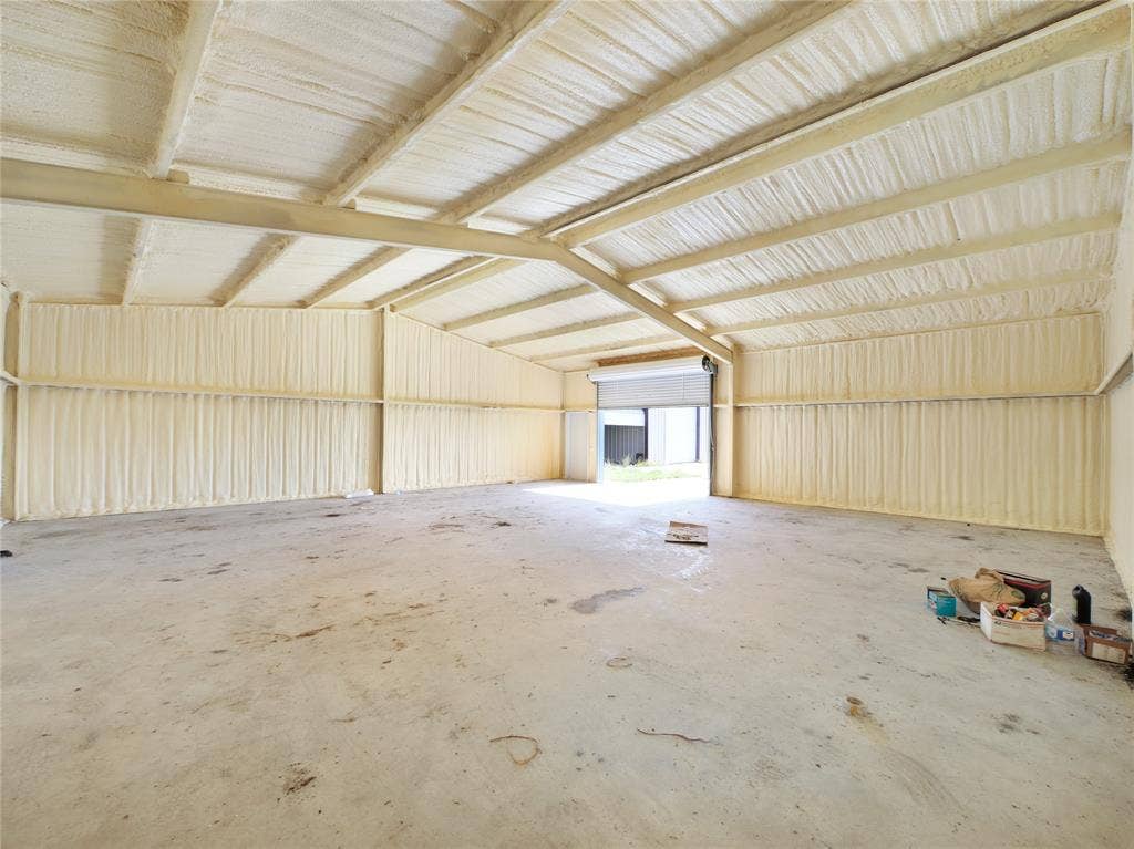 2944 CR-596, Nevada, TX 75173 Spacious metal-frame structure with high vaulted ceilings, exposed beam construction, and corrugated metal paneling throughout