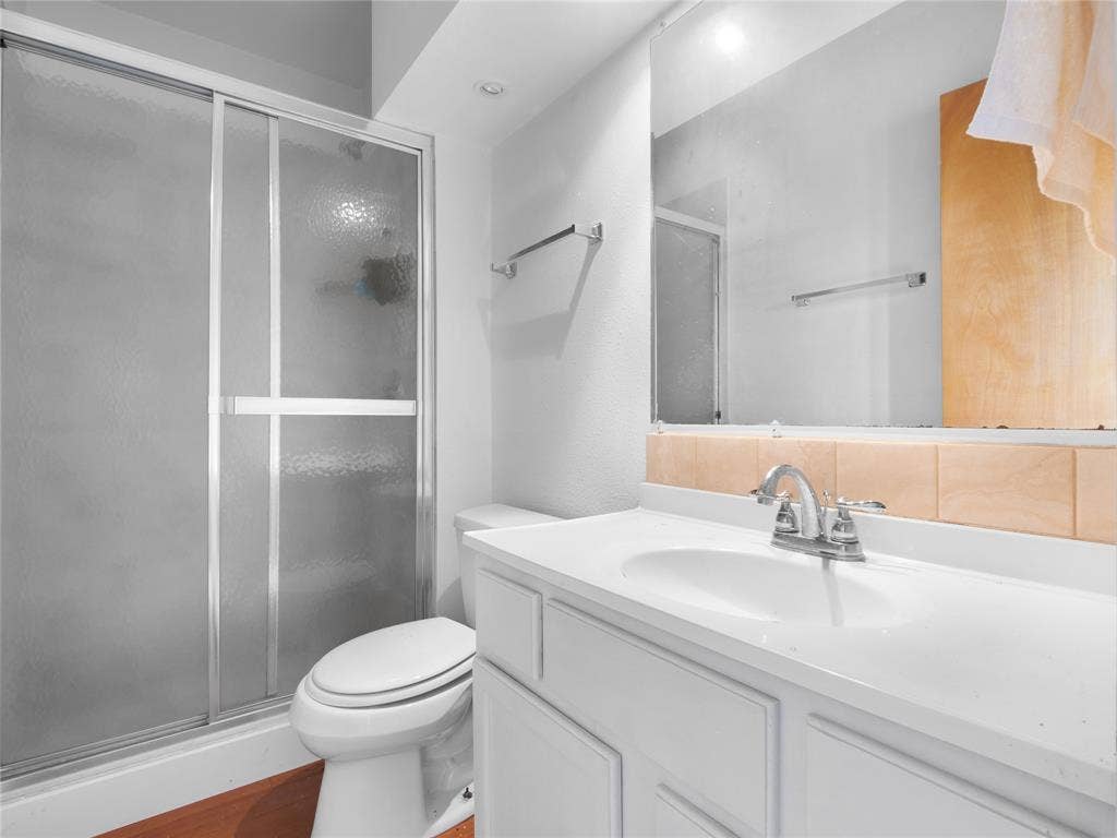 2944 CR-596, Nevada, TX 75173 White vanity with integrated sink, chrome faucet, and full-width mirror