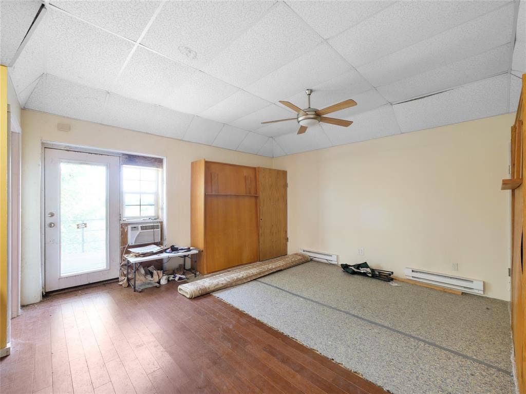 2944 CR-596, Nevada, TX 75173 Wood-finish flooring, drop ceiling, and a ceiling fan