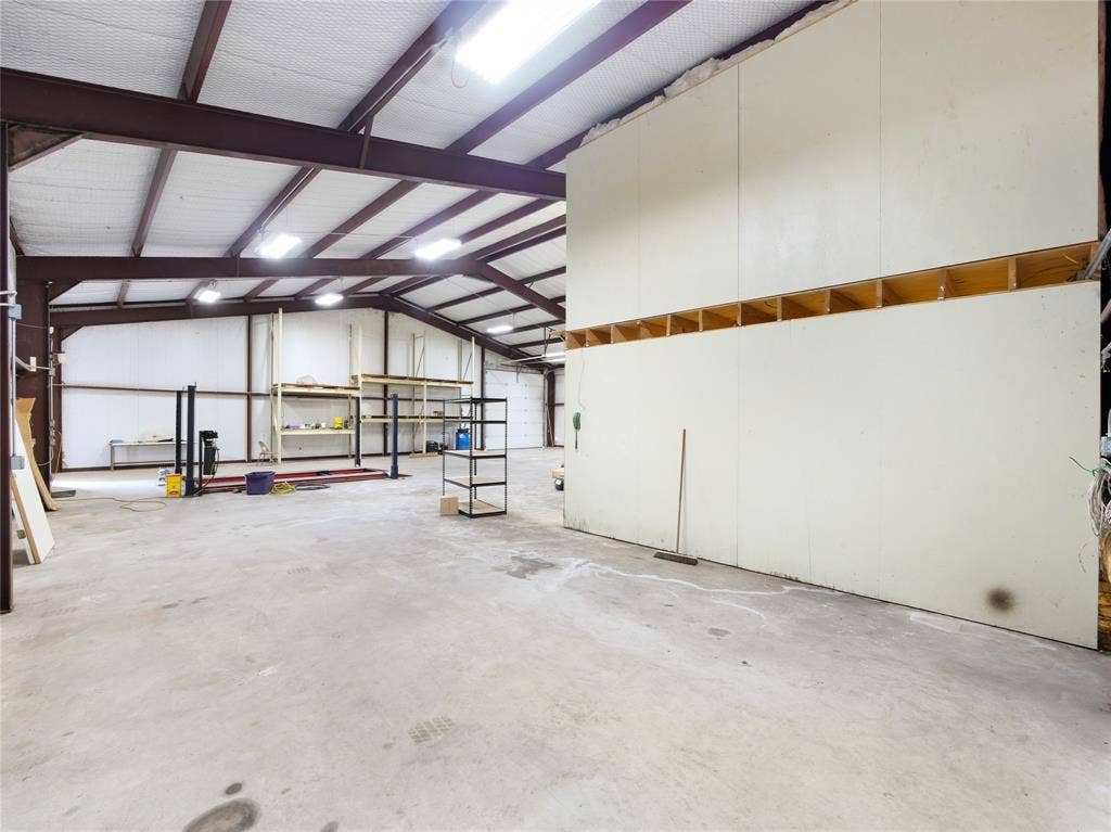 2944 CR-596, Nevada, TX 75173 Expansive commercial interior with concrete flooring and exposed beam ceiling structure