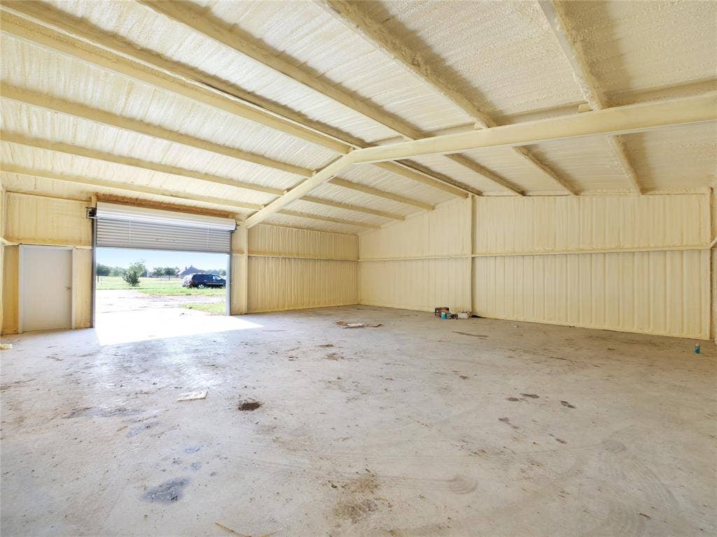 2944 CR-596, Nevada, TX 75173 Spacious interior with concrete flooring and exposed metal beams