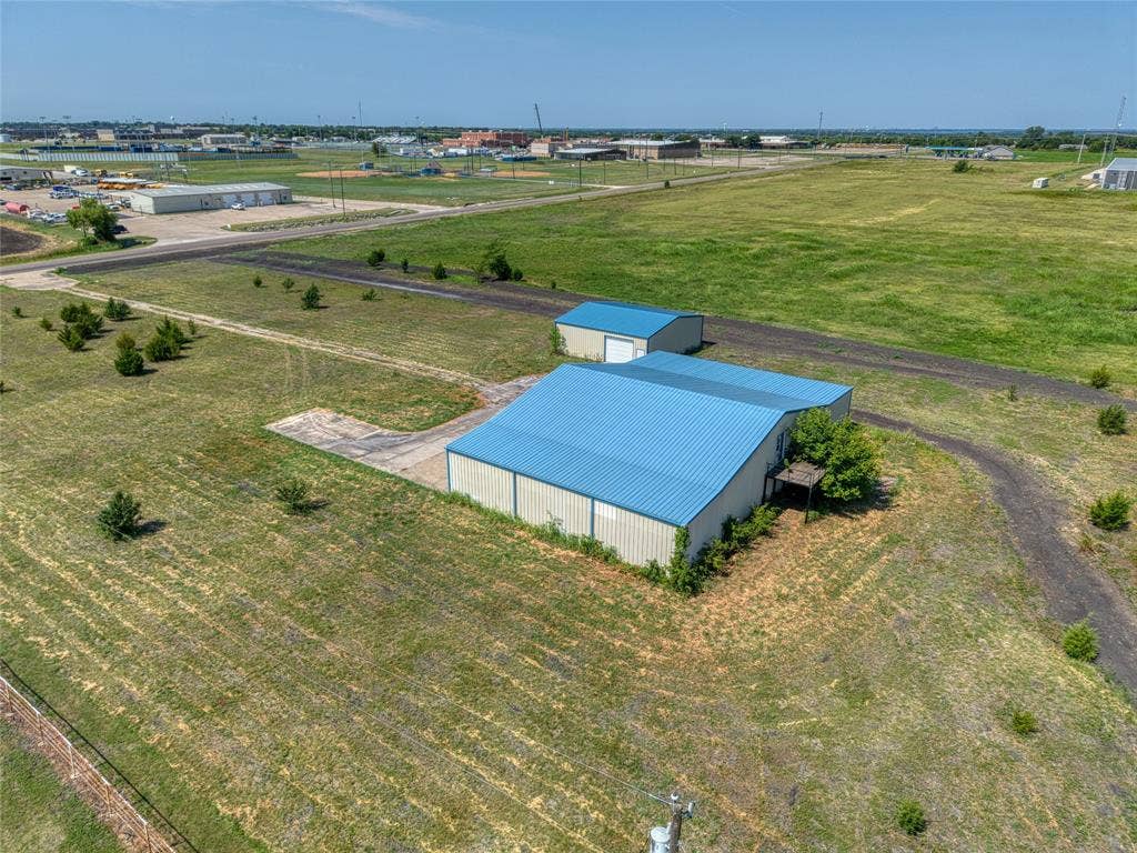 2944 CR-596, Nevada, TX 75173 Two metal outbuildings with blue roofs situated on a grass lot