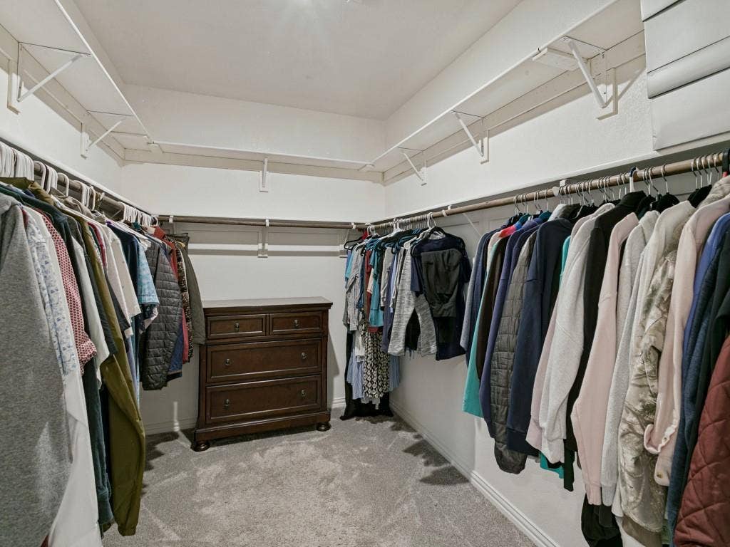 5513 Baker Creek Road, Fort Worth, TX 76126 Recessed ceiling lighting, wall-mounted shelving, multiple clothing rods, and carpeting