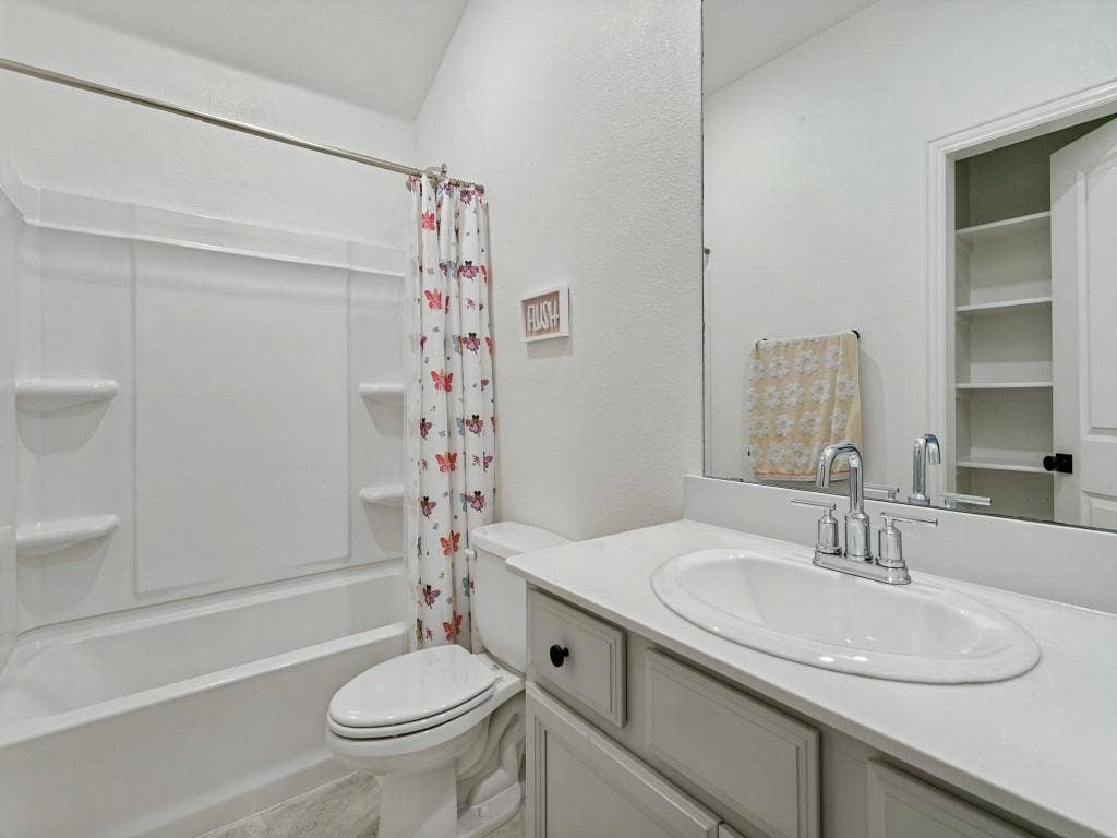 5513 Baker Creek Road, Fort Worth, TX 76126 White solid surface vanity with an integrated oval sink, chrome faucet, and a large mirror