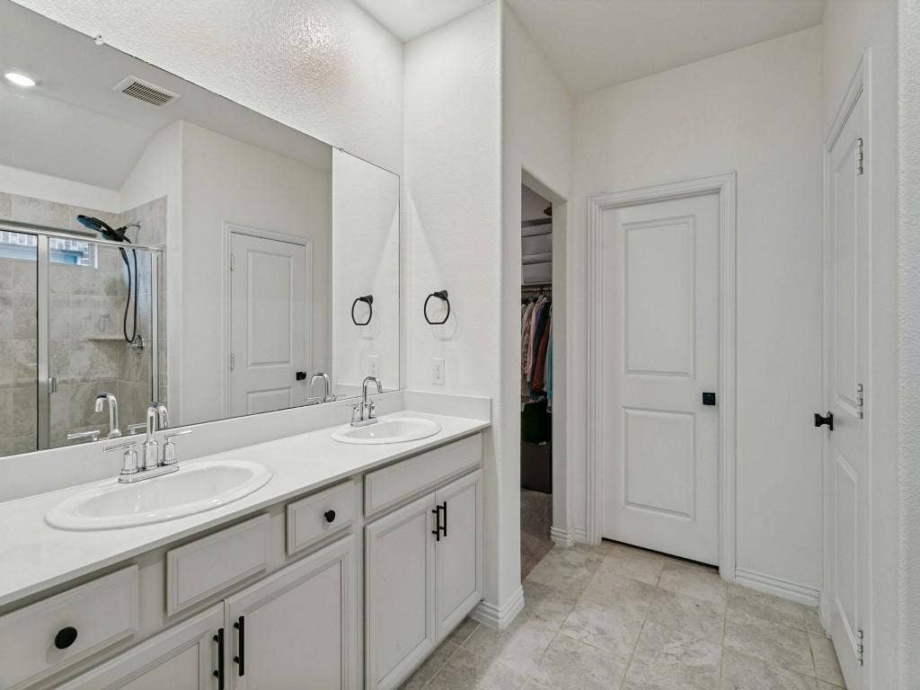 5513 Baker Creek Road, Fort Worth, TX 76126 Dual vanity with white cabinetry and integrated sinks