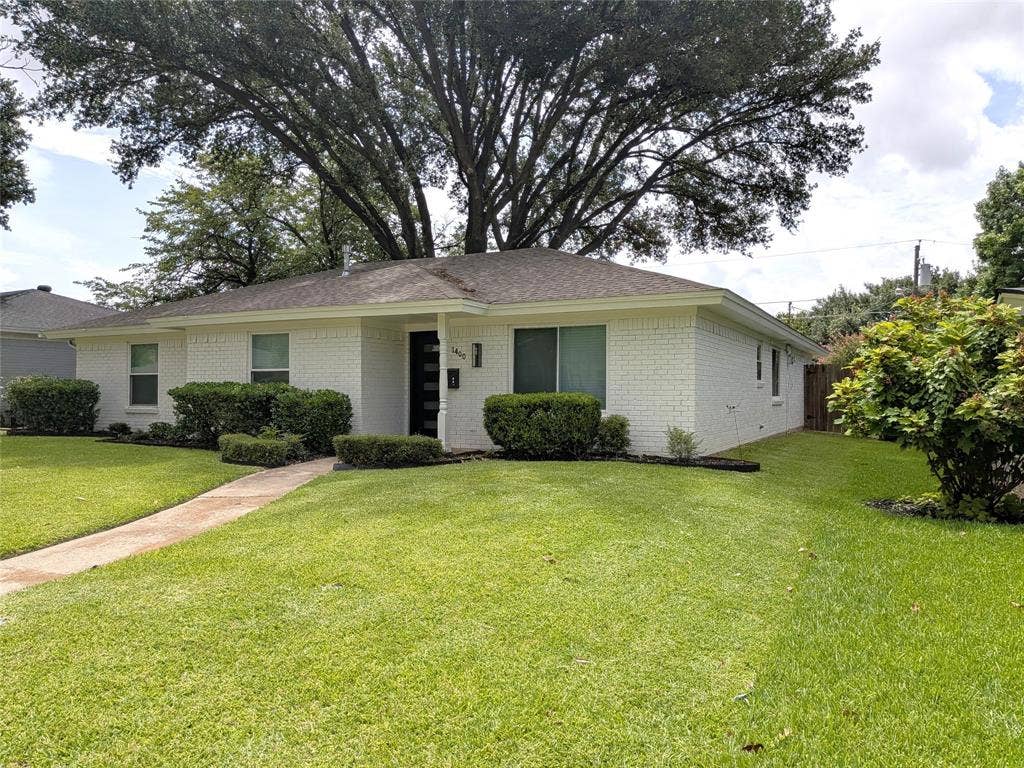 1400 Oakhill Drive, Plano, TX 75075 Single-story residence featuring a white brick exterior and a dark roof