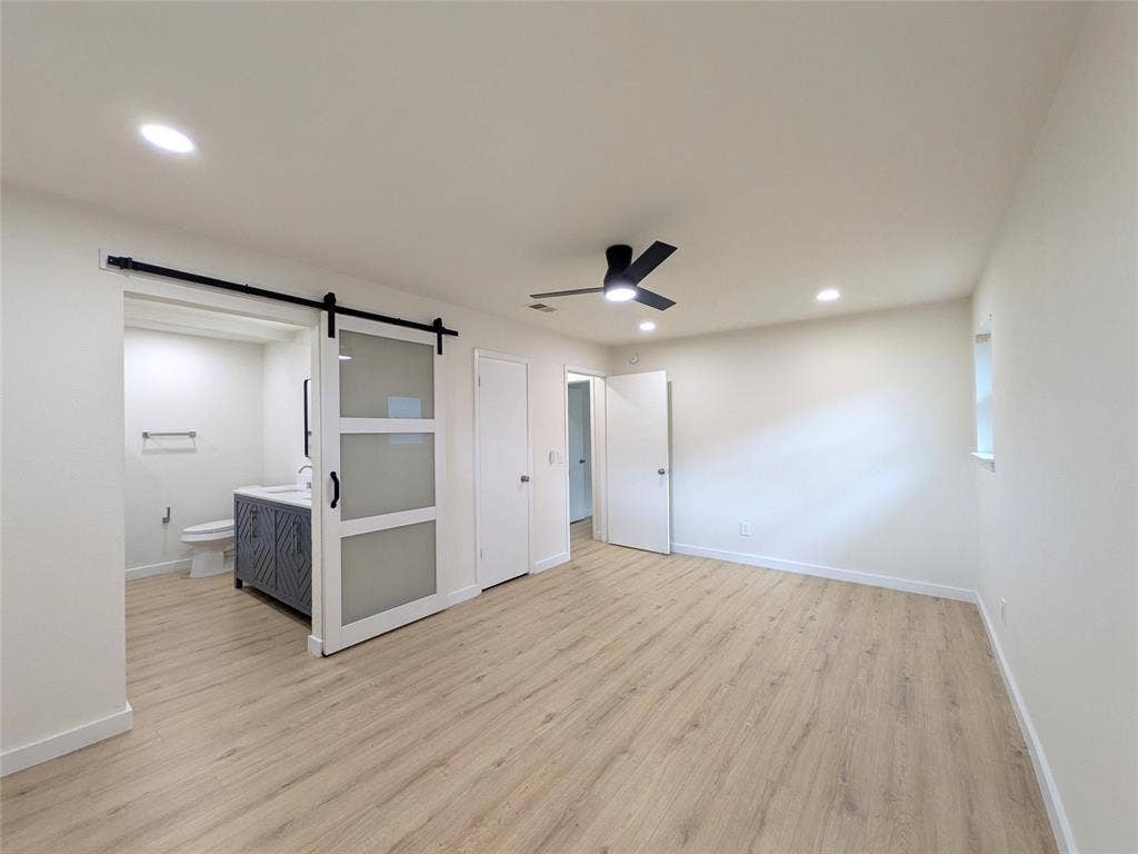 1400 Oakhill Drive, Plano, TX 75075 Spacious room featuring wood-finish flooring, recessed lighting, and a contemporary ceiling fan